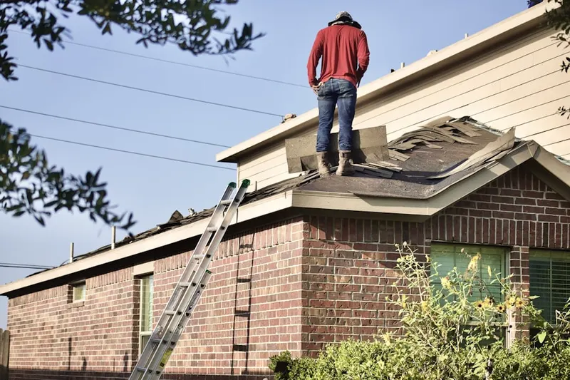 Professional roofer working on a residential roof in Folcroft